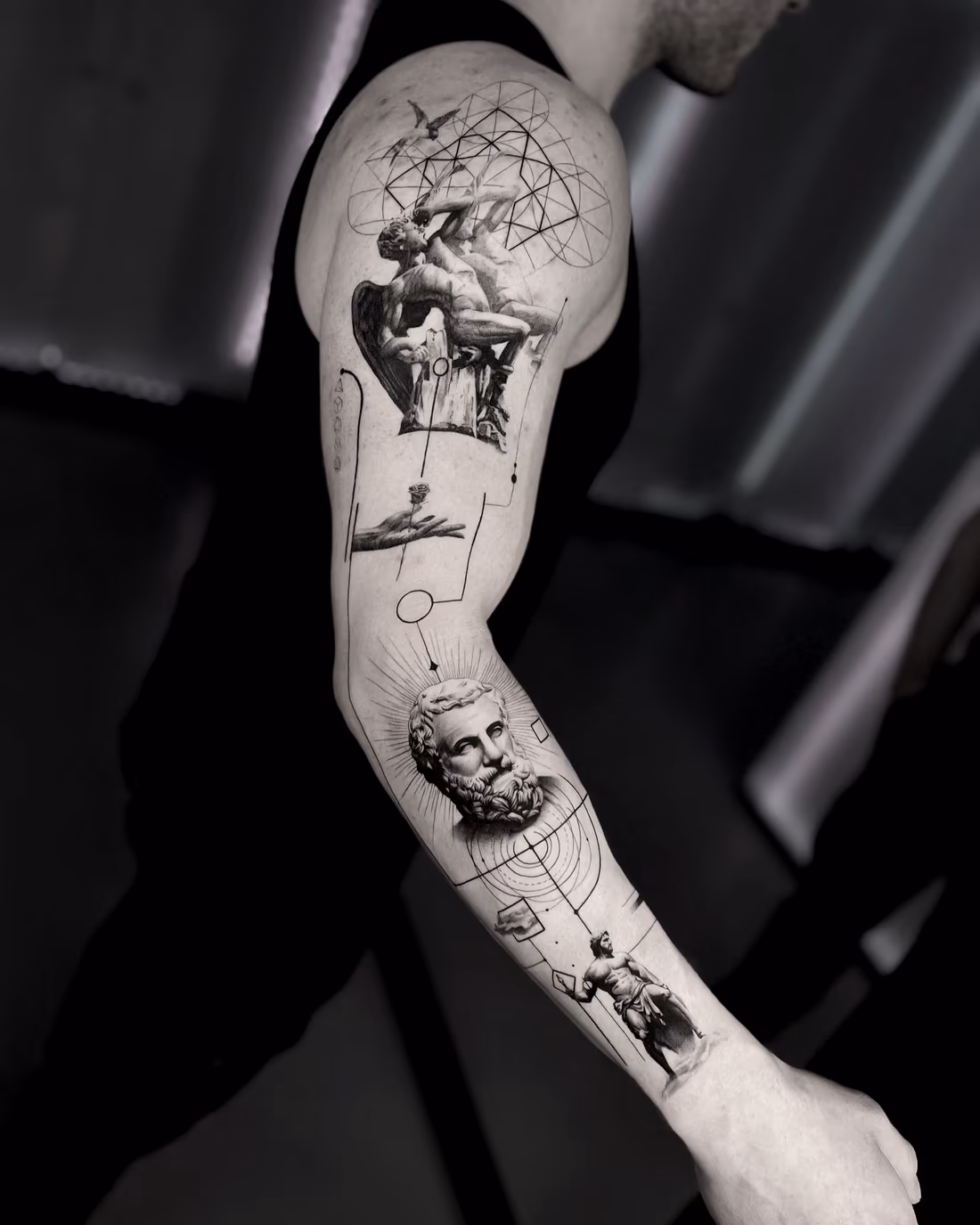 Several classical figures and portraits bound together by fine geometry along the length of the arm